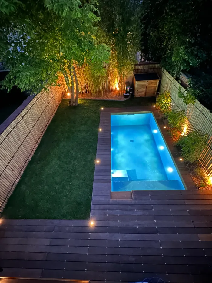 Overall view of the landscaped urban garden around the pool, exotic timber decking